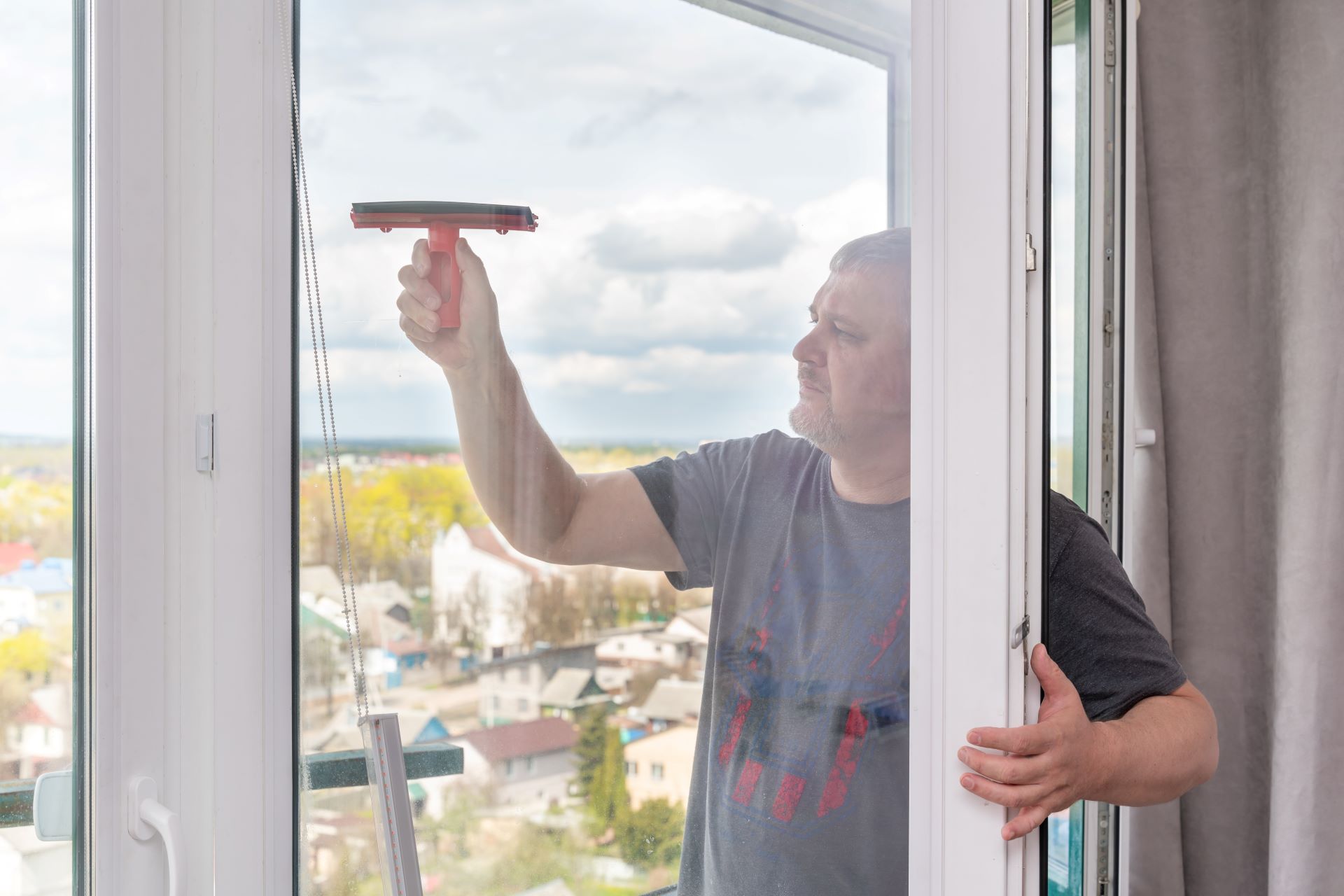 caucasian elderly man washing a window with a brus 2023 11 27 05 12 24 utc